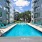Large sparkling blue pool with a large pool deck and lounge chairs