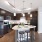 Spacious and well lit kitchen with wood flooring and stainless steel appliances