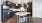 Spacious and well lit kitchen with wood flooring and stainless steel appliances