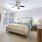 Large well lit bedroom with plush carpets and large windows 