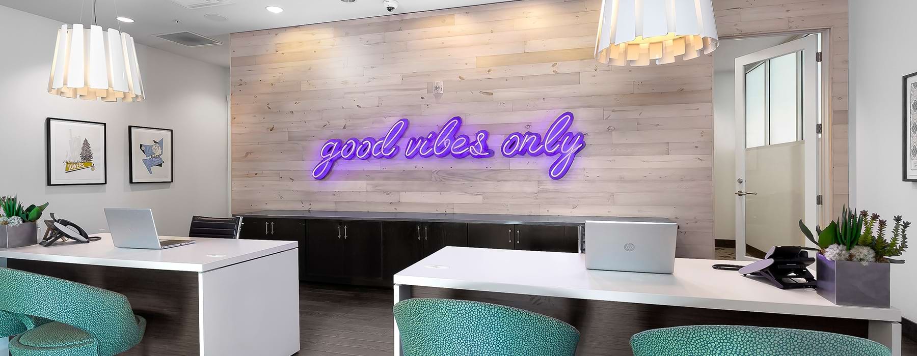Large well lit leasing office with large neon sign 
